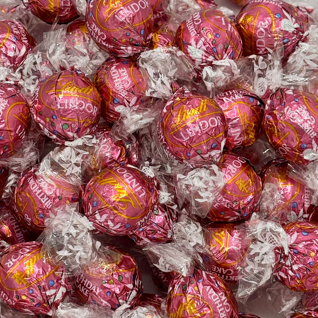 Close-up of purple birthday cake truffles in foil twist wraps