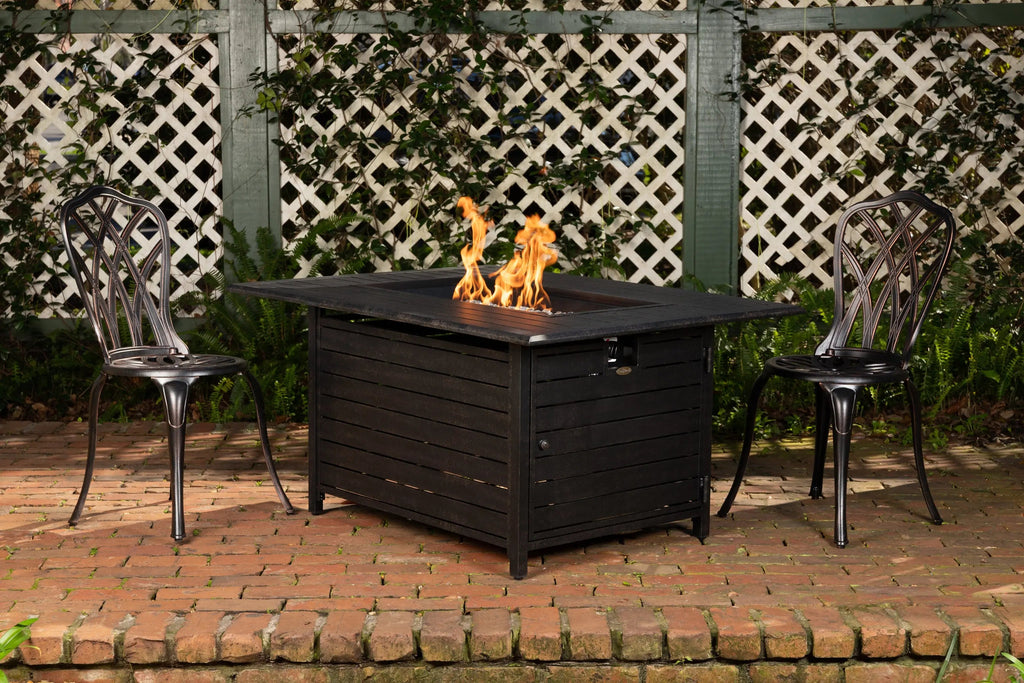 Rectangular dark gas fire pit table with open center showing flames and fire media.