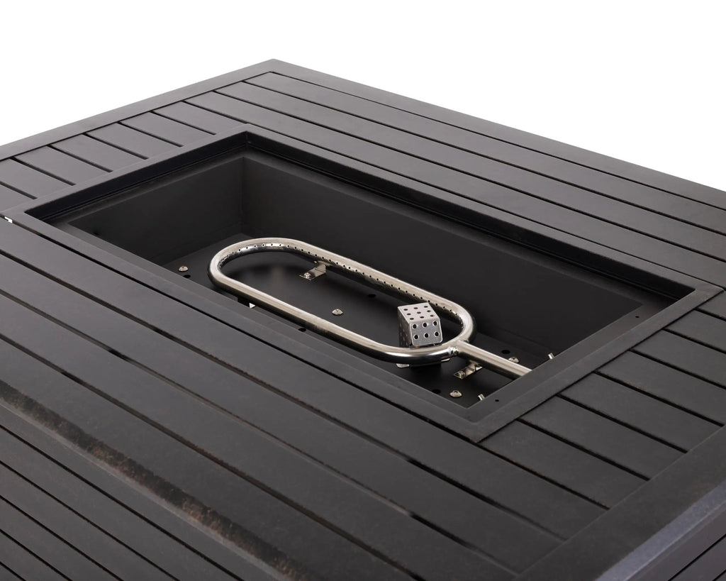 Close-up of open fire pit burner with ring igniter inside a dark rectangular table.