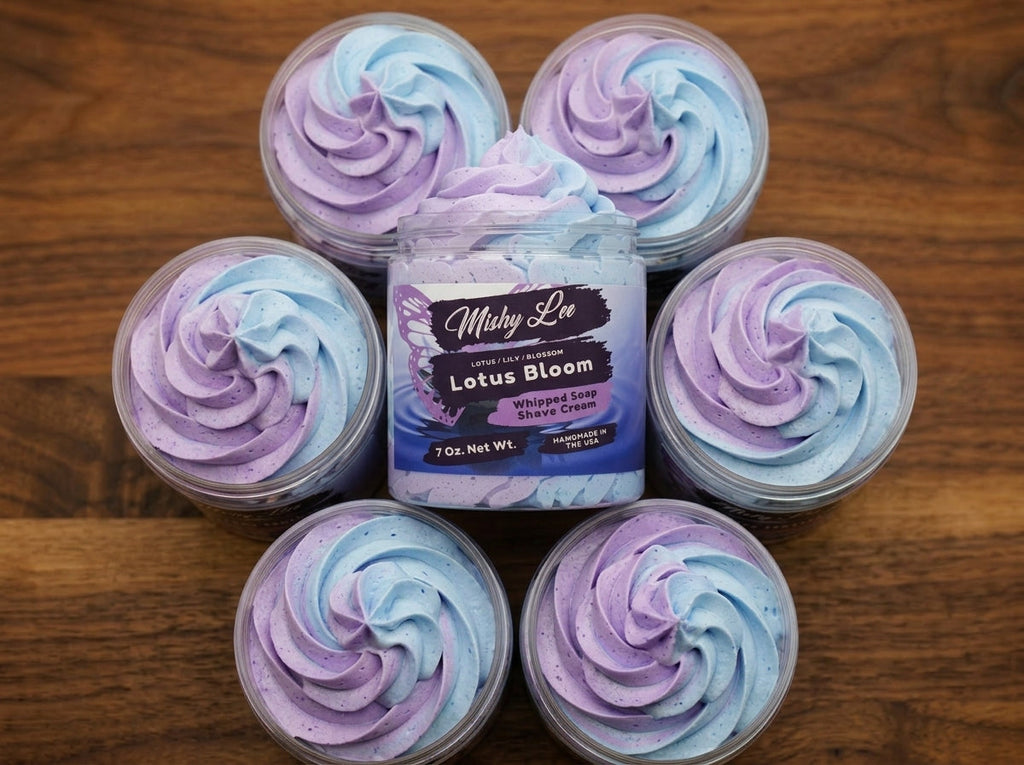 Six small jars of whipped soap with pastel purple and blue swirls on wood