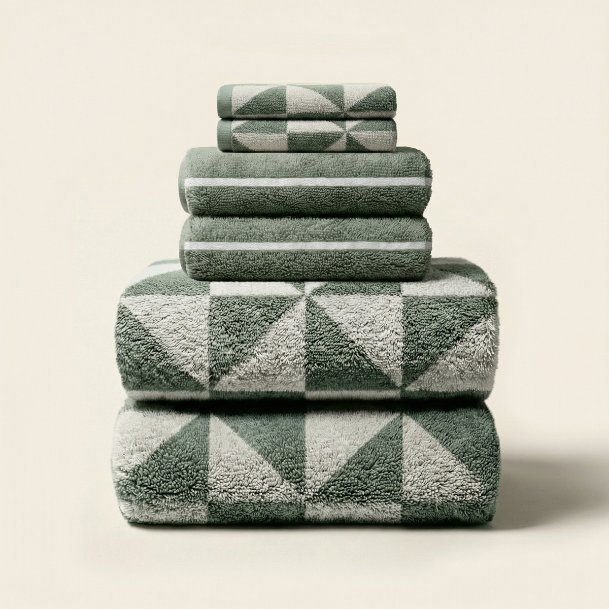 Folded sage and cream towels with bold geometric square pattern