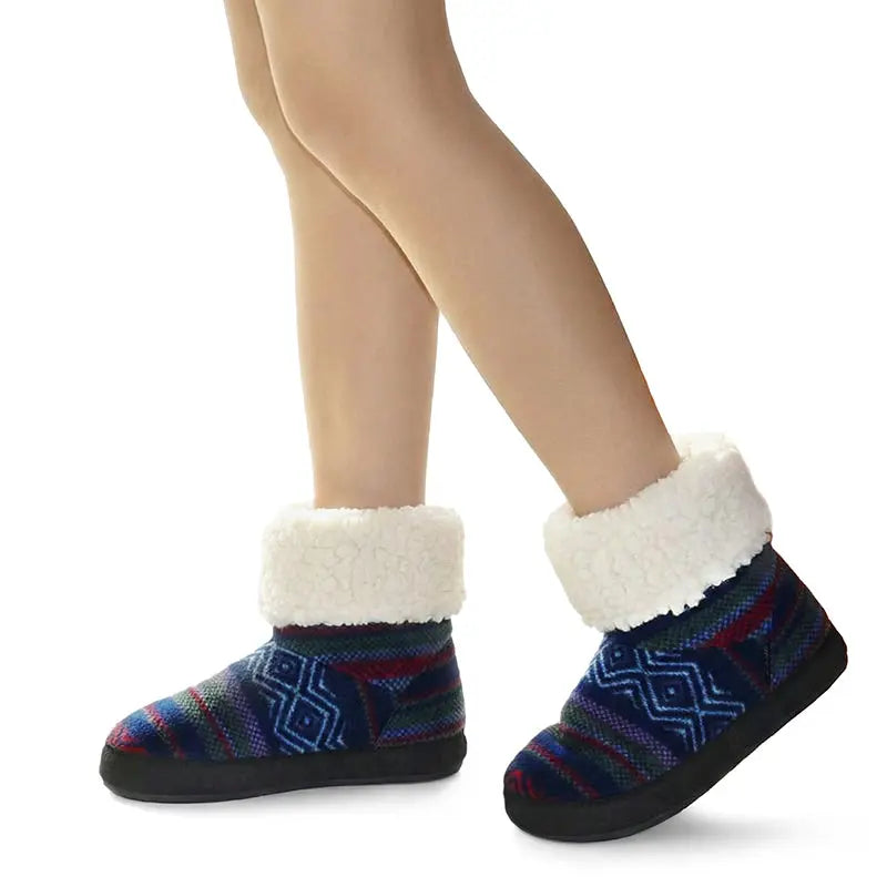 Women’s Nordic knit booties worn with sherpa cuffs, navy geometric pattern, dark soles