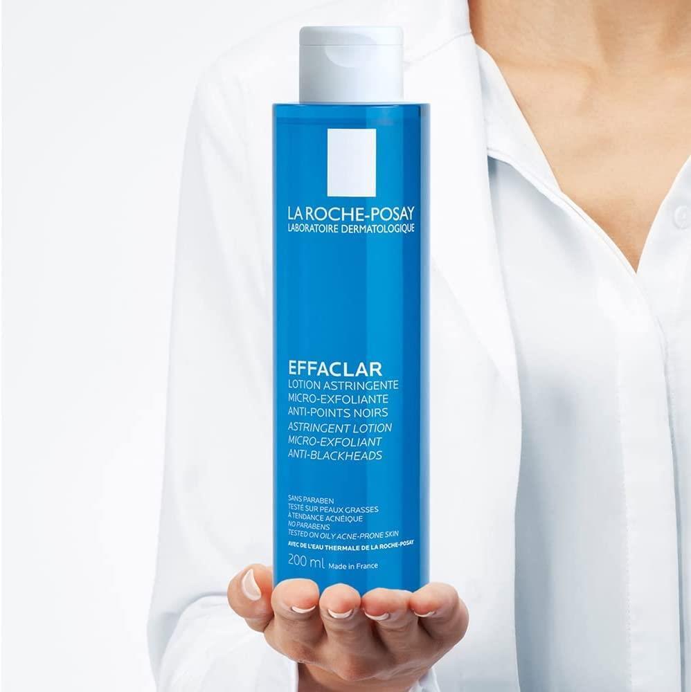 Effaclar face toner bottle held by hand, blue bottle with white cap