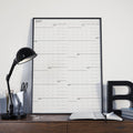 Large wall calendar with 2027 monthly grid and black binding, landscape layout