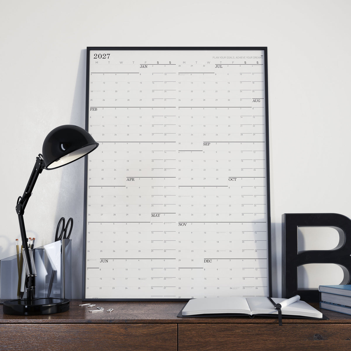 Large wall calendar with 2027 monthly grid and black binding, landscape layout