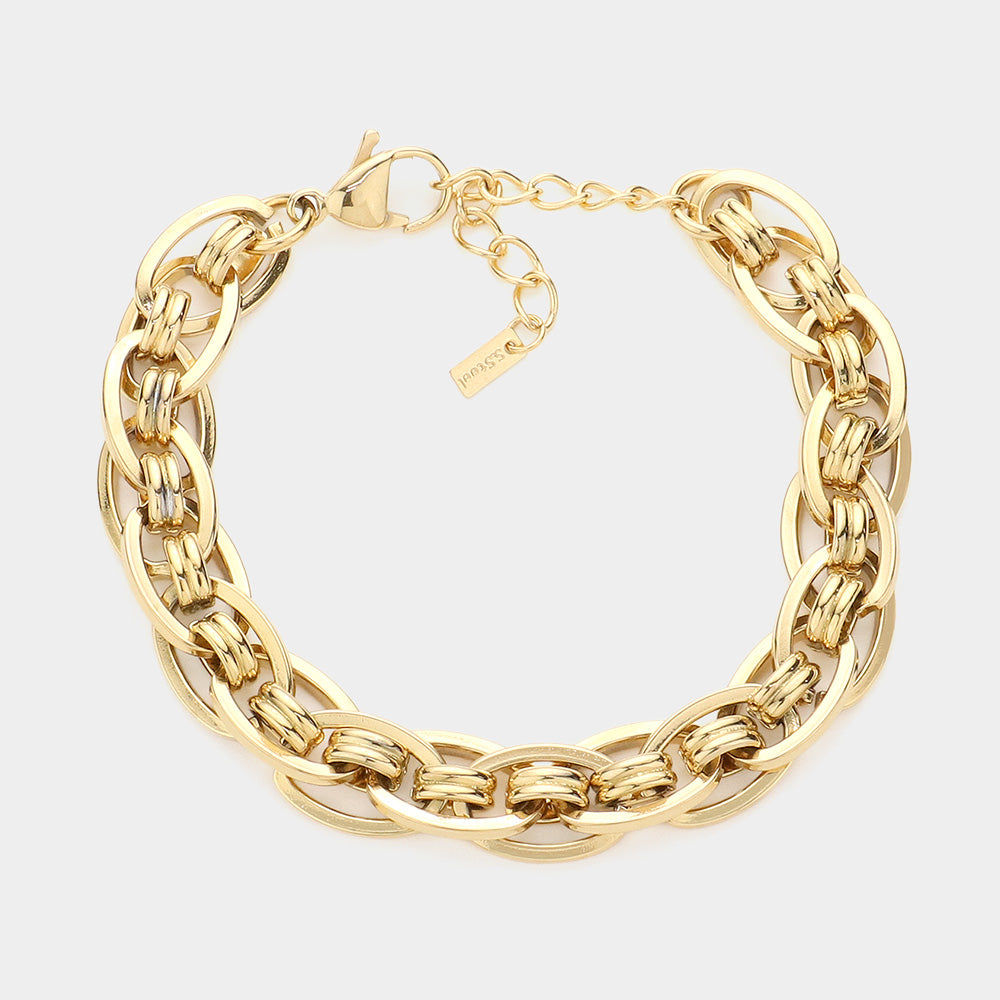 Gold chain link bracelet with layered links, heart clasp, and small dangling tag
