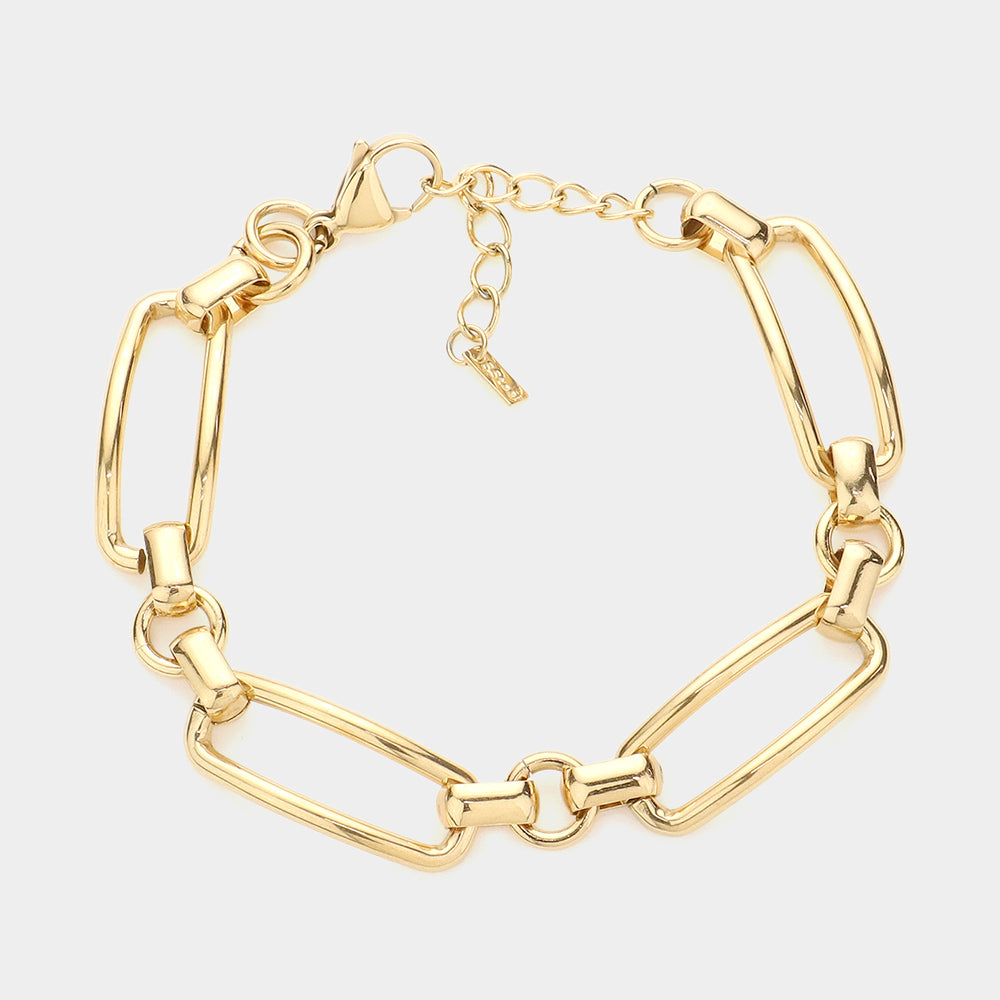 Gold bracelet with oval and rectangular chain links, heart clasp, dangling charm
