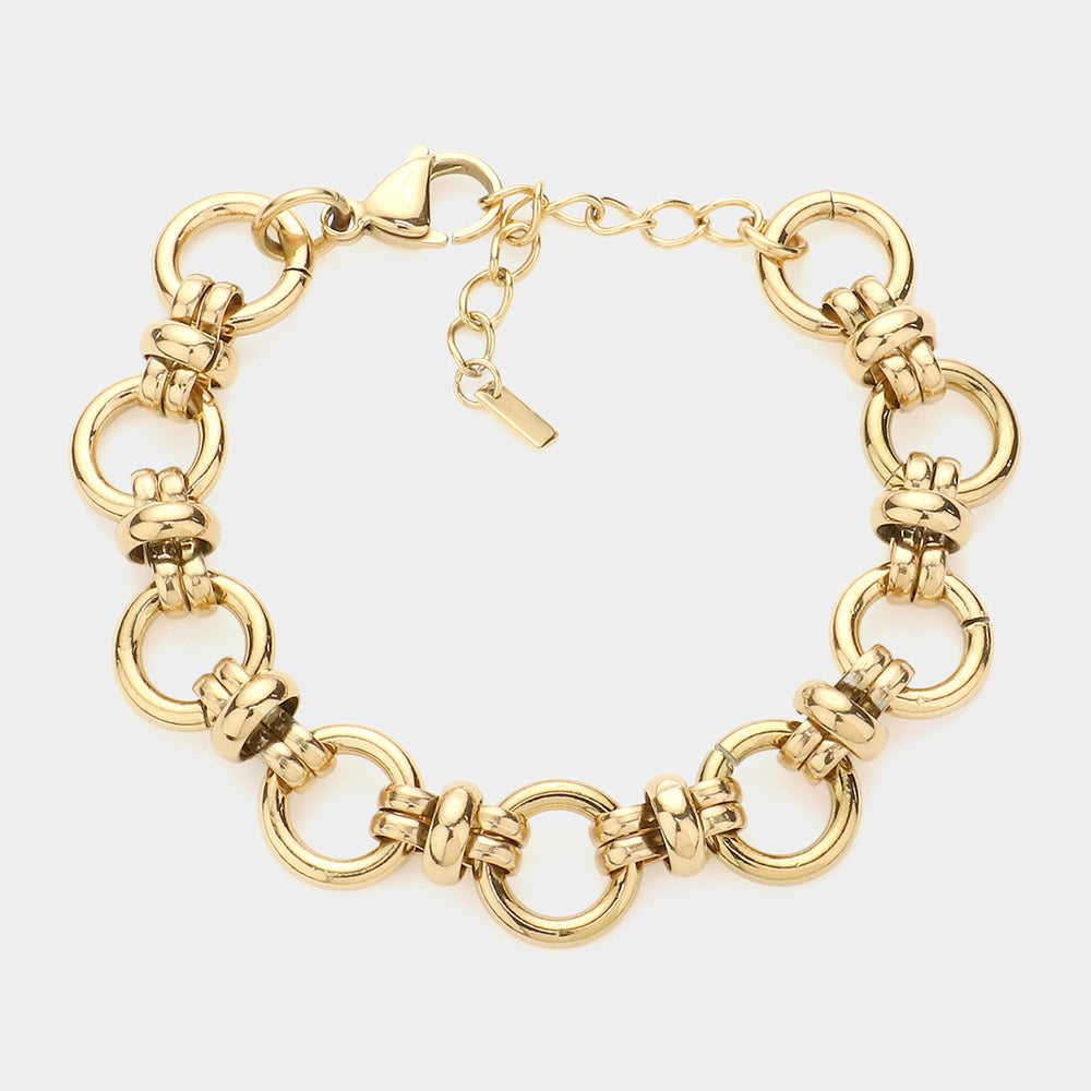 Gold chunky chain bracelet with oval links, heart clasp, and dangling charm tag