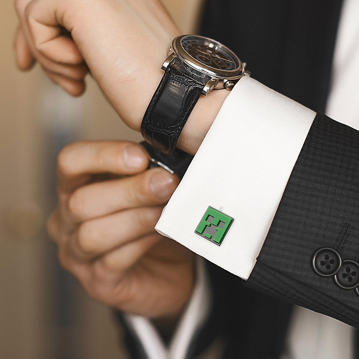 Green Creeper enamel cufflinks on white shirt cuff, worn on wrist