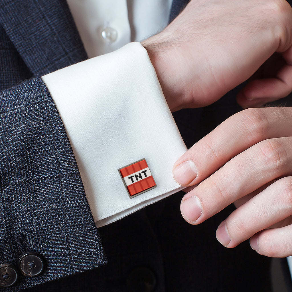 TNT red-and-black enamel cufflink on white shirt cuff, close-up