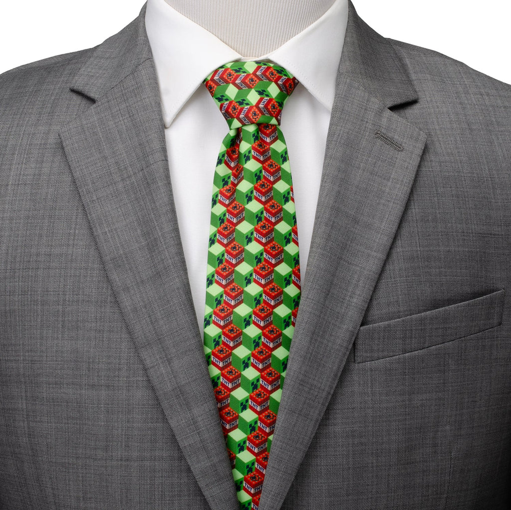 Men's dress tie with green, red, and white block pattern; shown on a shirt