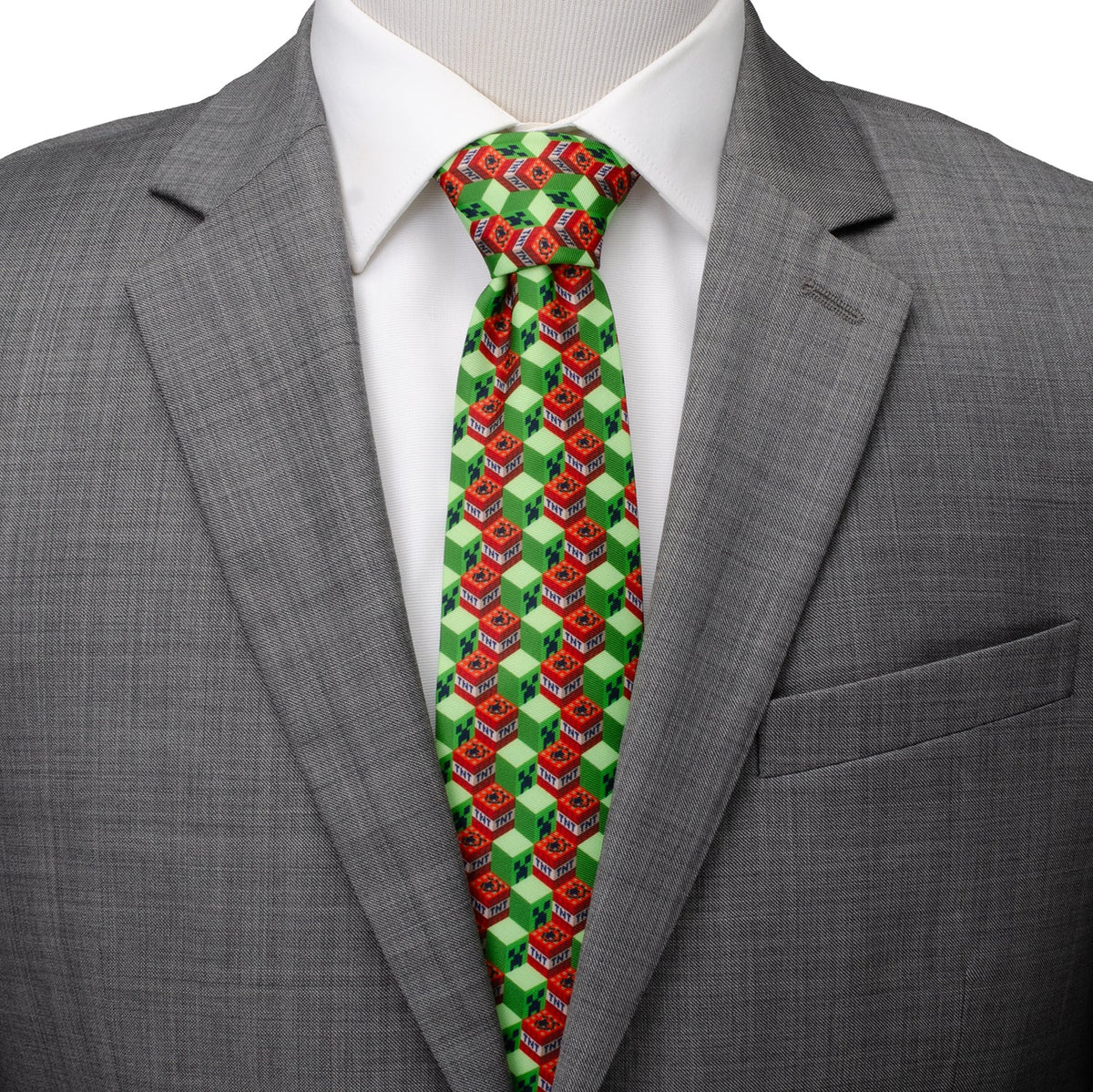 Men's dress tie with green, red, and white block pattern; shown on a shirt