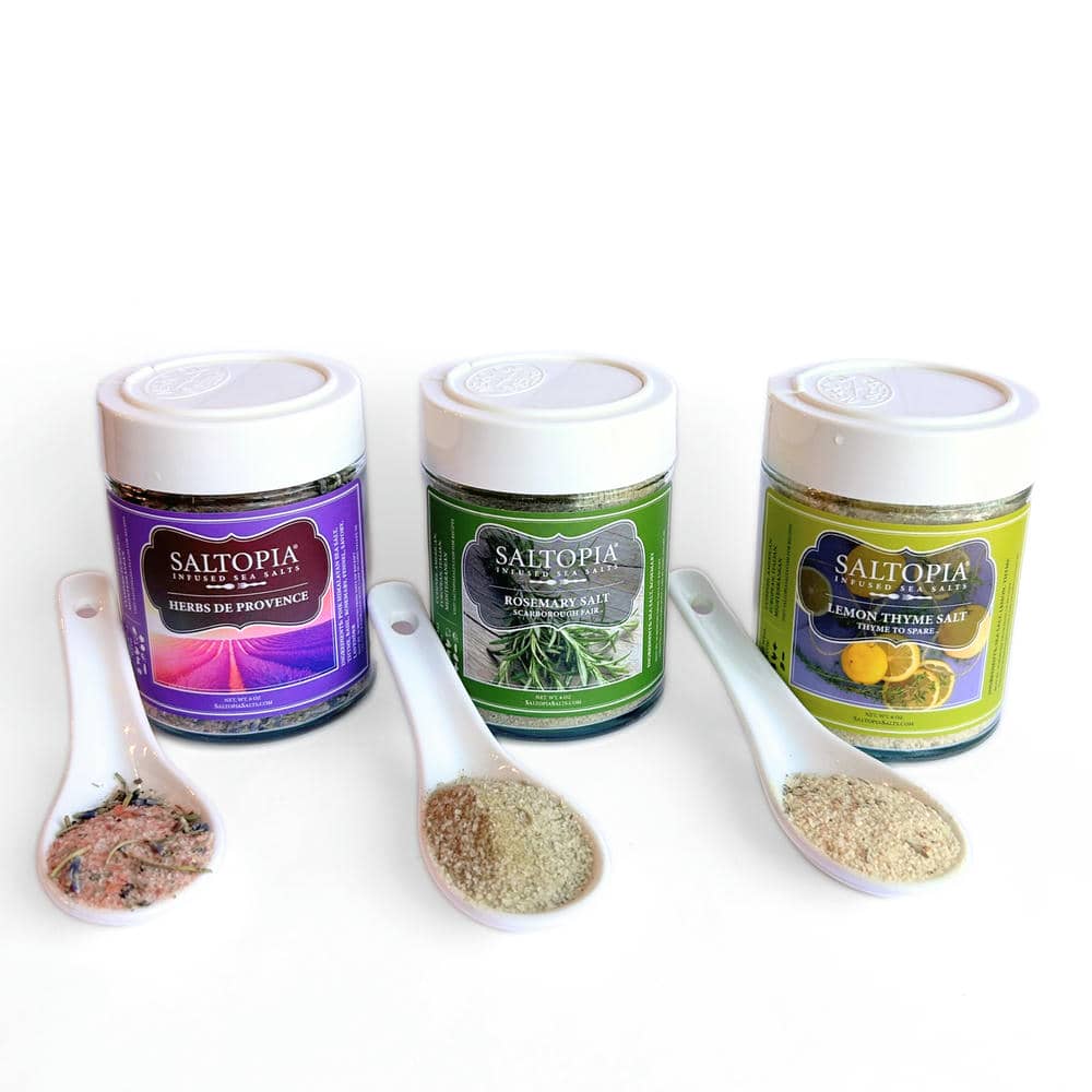 Mediterranean kitchen gift set seasoning jars with herb sample scoops on white tray.