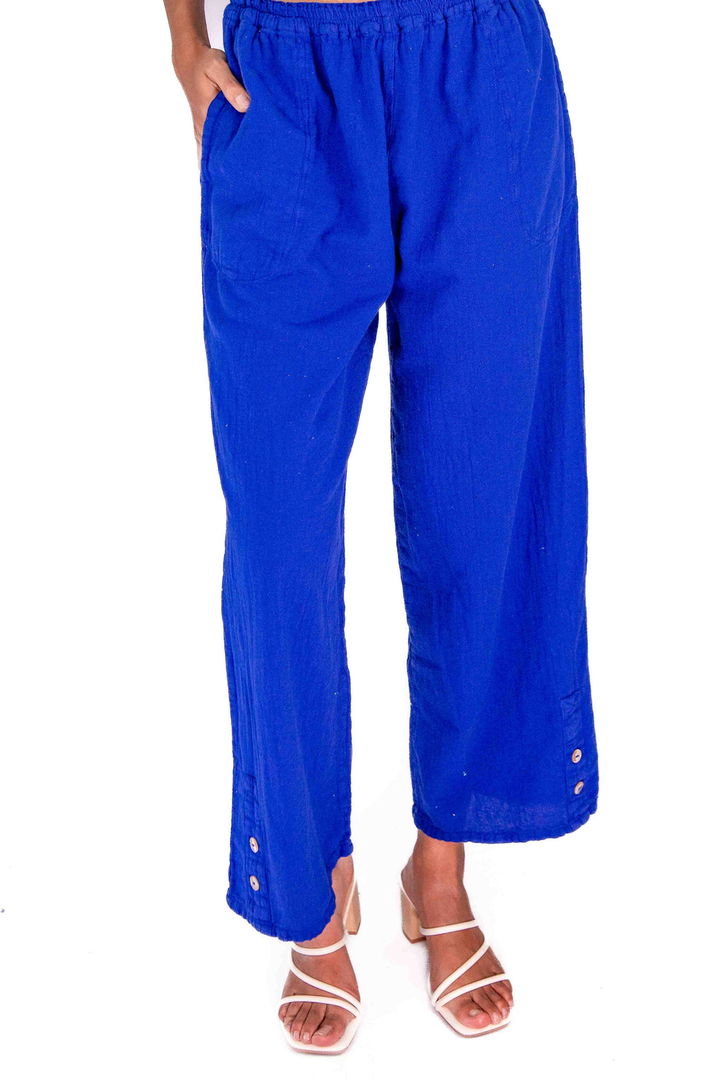 Royal blue cotton gauze pants with elastic waistband, loose wide leg, ankle length, button hem detail