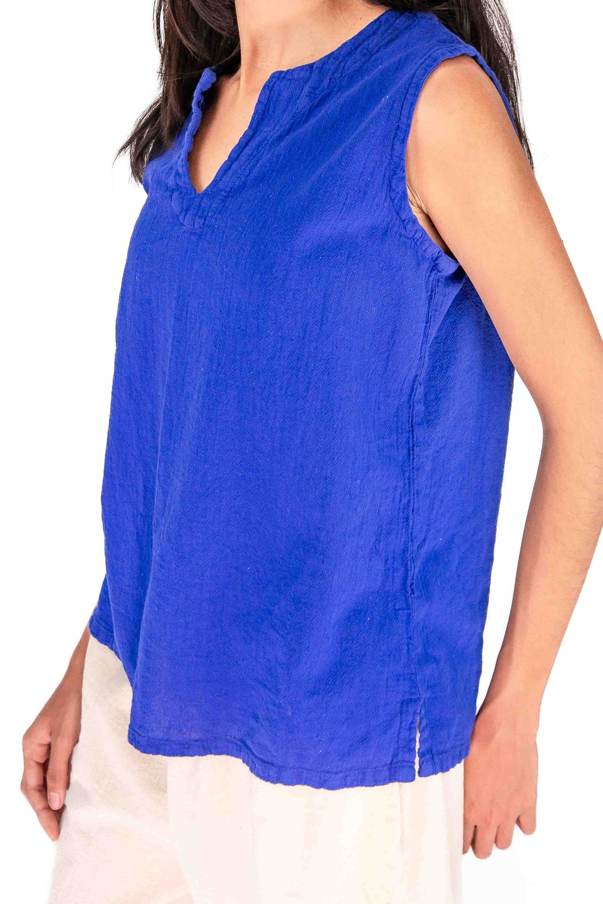 Blue sleeveless cotton gauze top with V-neck and curved hemline