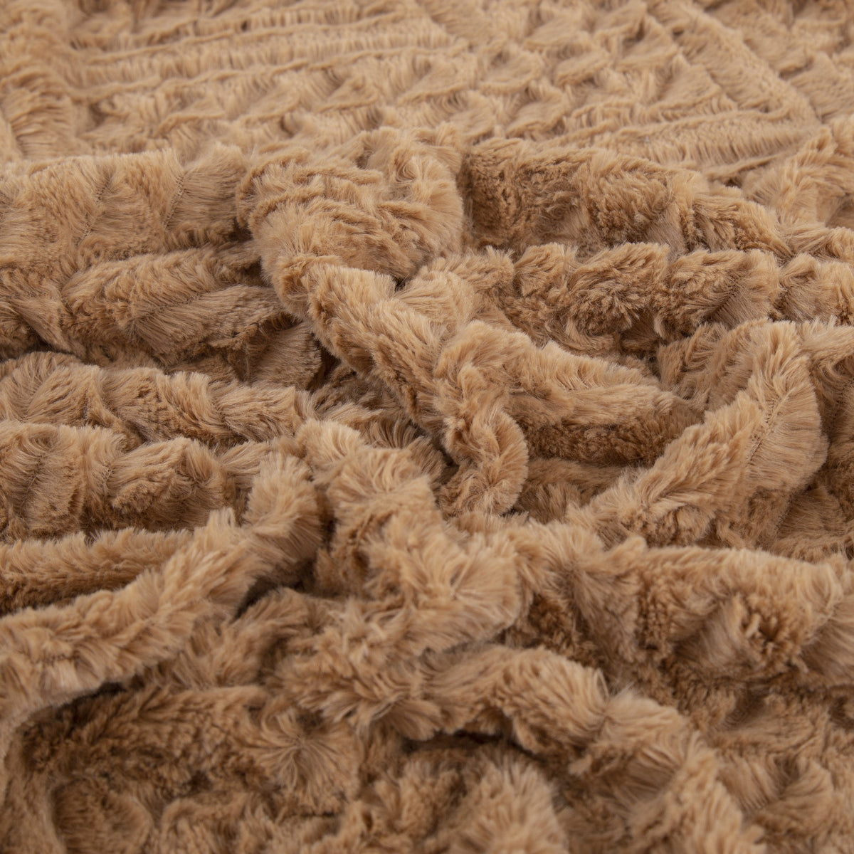 Caramel brown faux fur throw blanket close-up, dense textured loops