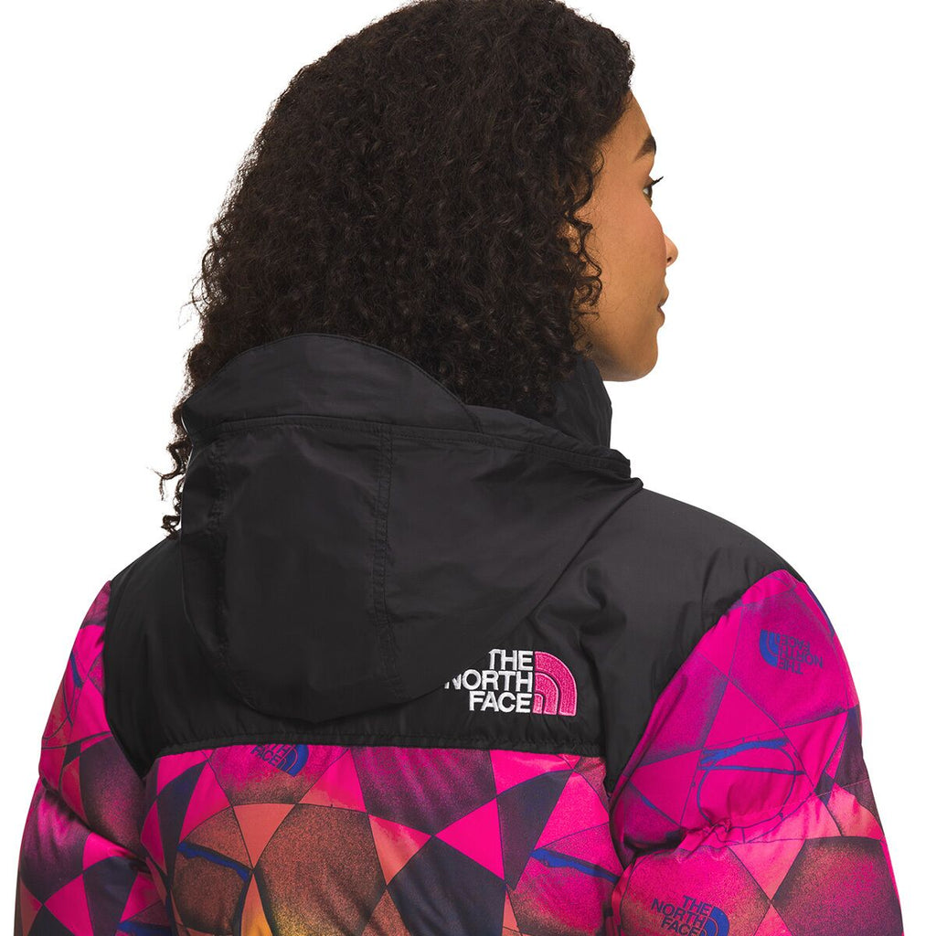 Women's black puffer jacket hood with pink geometric sleeve panels and zip front