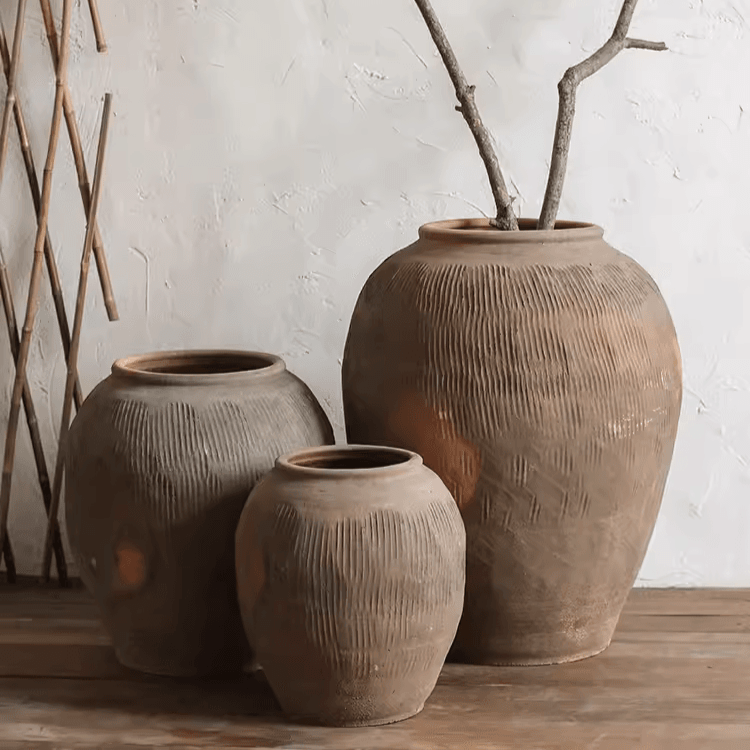 Brown earthenware round pot with ribbed texture and wide open top