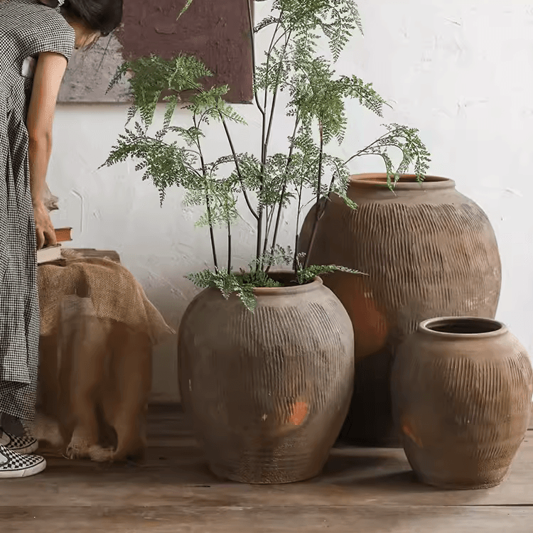 Set of brown ribbed round earthenware pots with wide openings