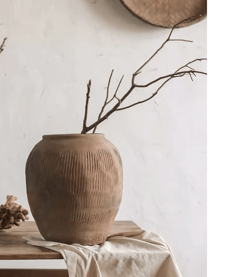 Brown ribbed earthenware round vase pot with wide opening and branch stems