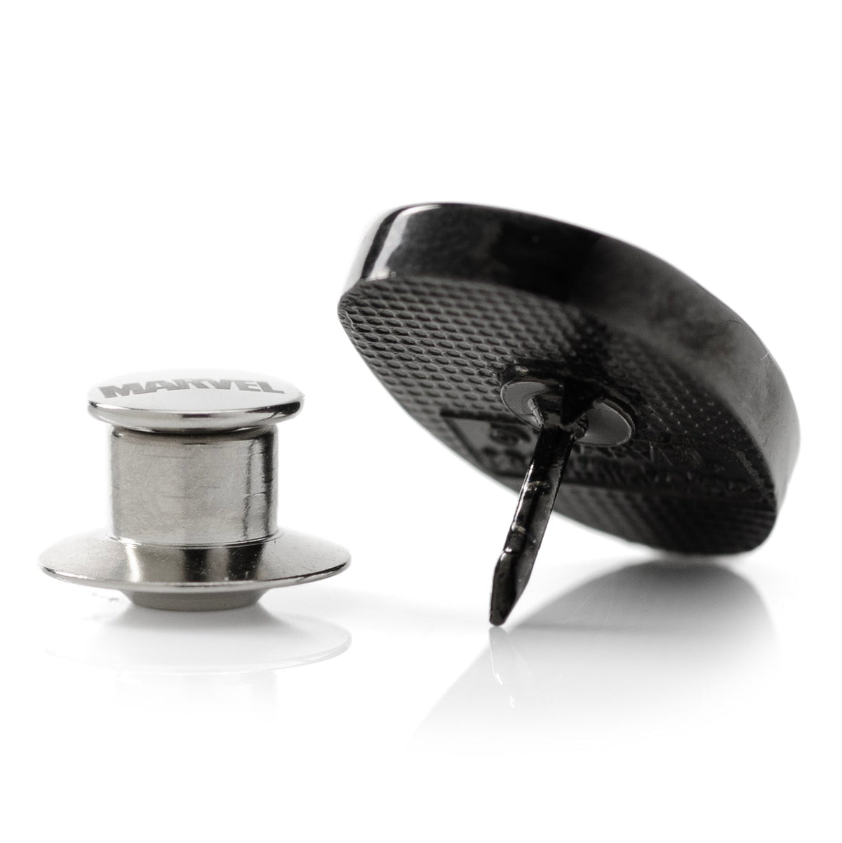 Cufflinks showing black textured discs and silver metal posts and backs