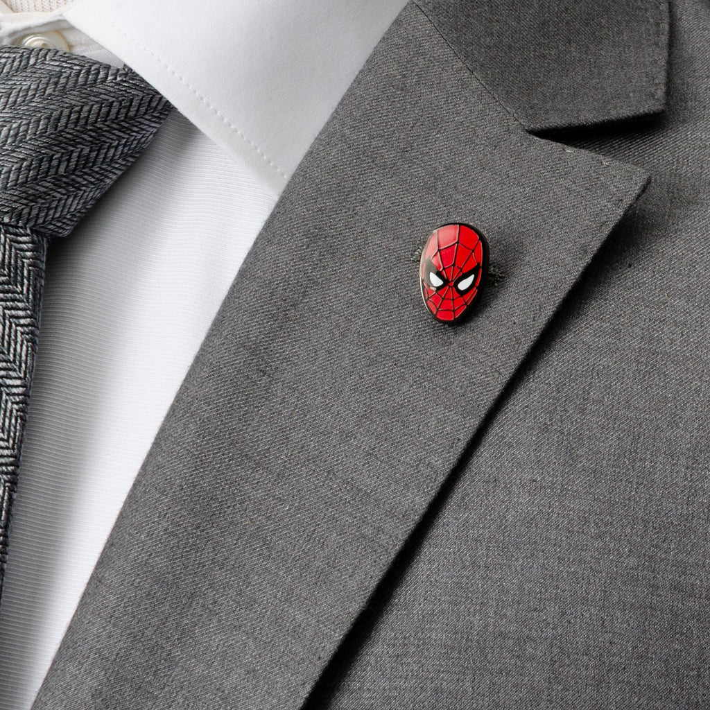 Spider-themed enamel lapel pin on a gray suit jacket lapel