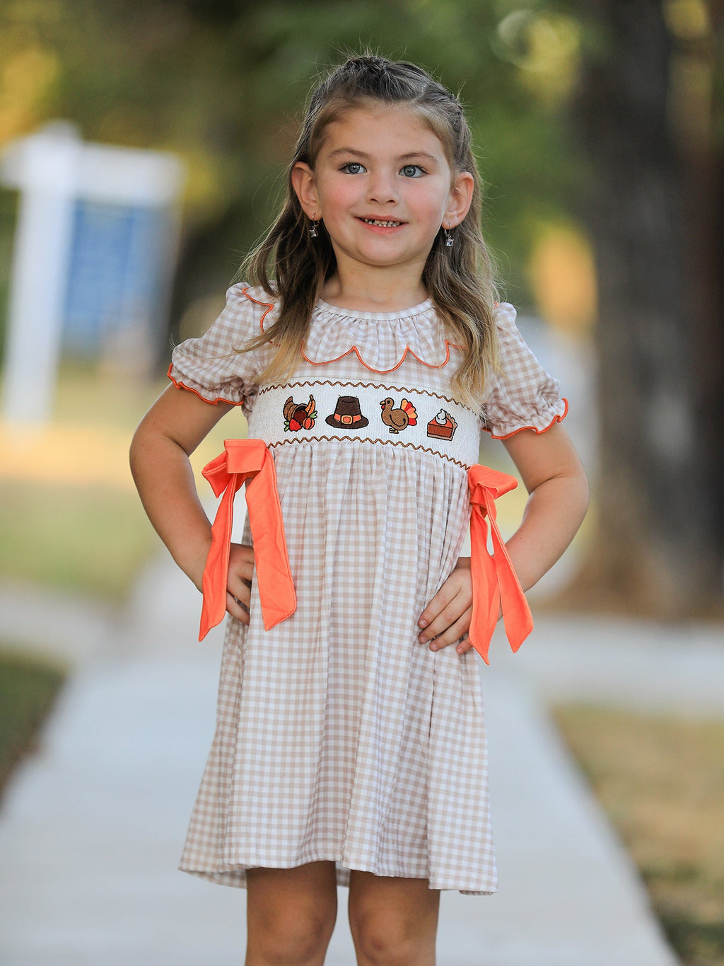 Girls gingham Thanksgiving dress with scalloped white collar and orange ribbon bows