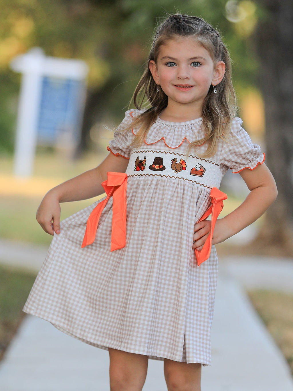 Girls gingham Thanksgiving dress with orange side bows and turkey-style embroidery