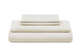 Light cream sateen bed sheets set, stacked folded sheets with visible seam lines