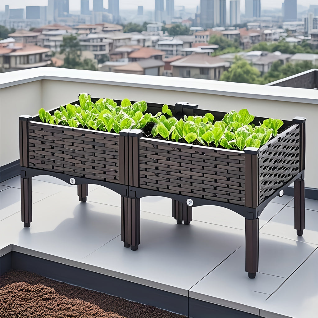 Raised garden planter box on balcony with dark woven sides and planted greens
