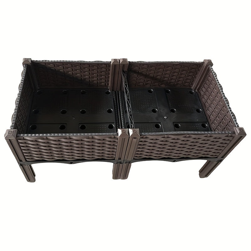 Expanded view of dark raised planter box with drainage holes and woven wall panels