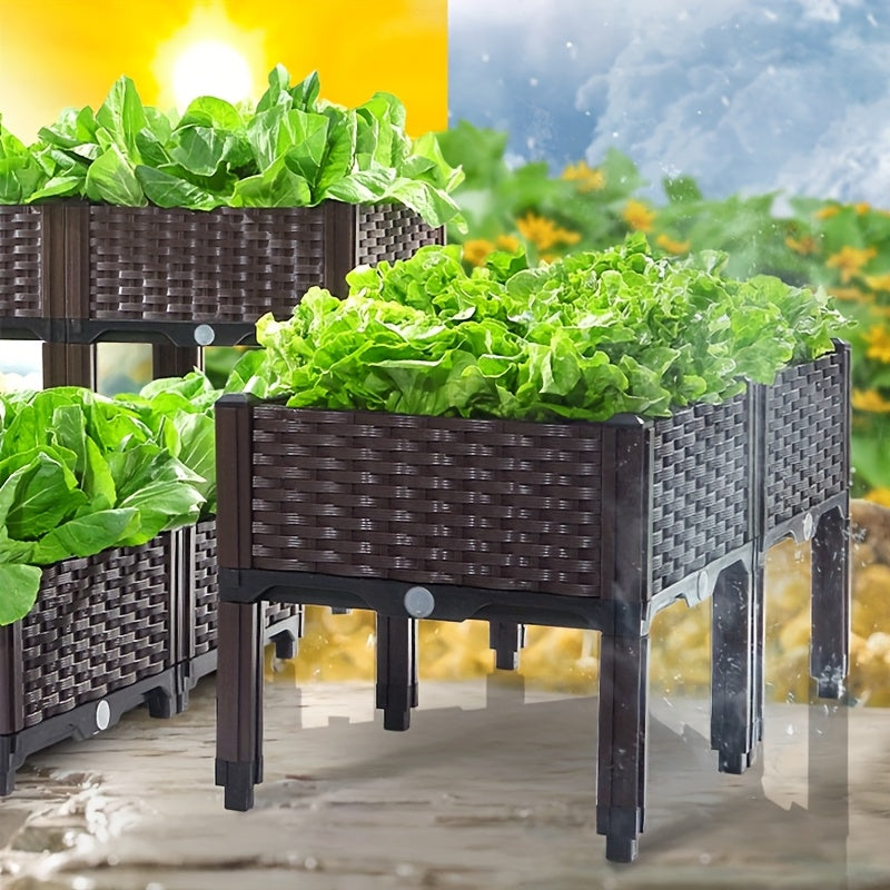 Dark raised garden planter box with woven sides and planted leafy greens