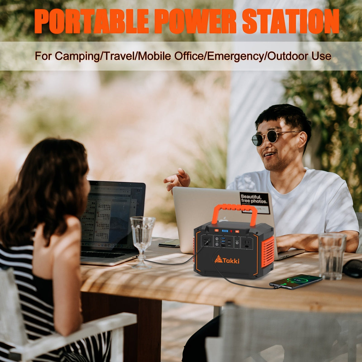 Portable power station on table with foldable solar panel, front control panel and outlets