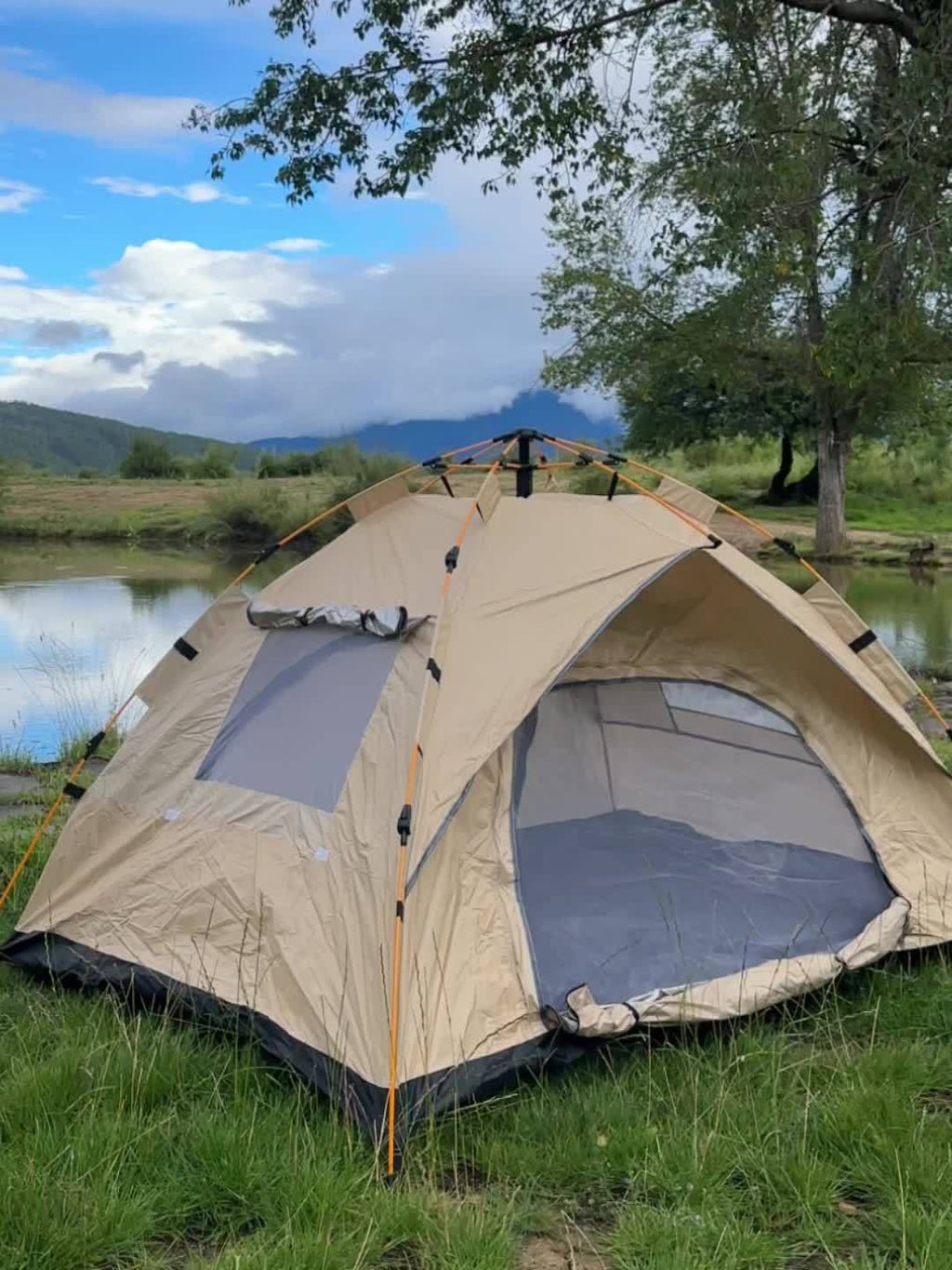 3-4 person pop-up camping tent with beige body and gray window panels, open entrance