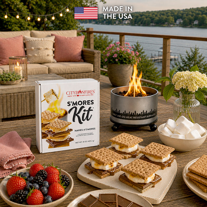 S'mores kit box with graham crackers and marshmallows beside a fire pit