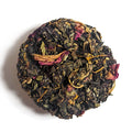 Mamma Mia No. 42 white tea disc with dark leaves, rose petals, and calendula