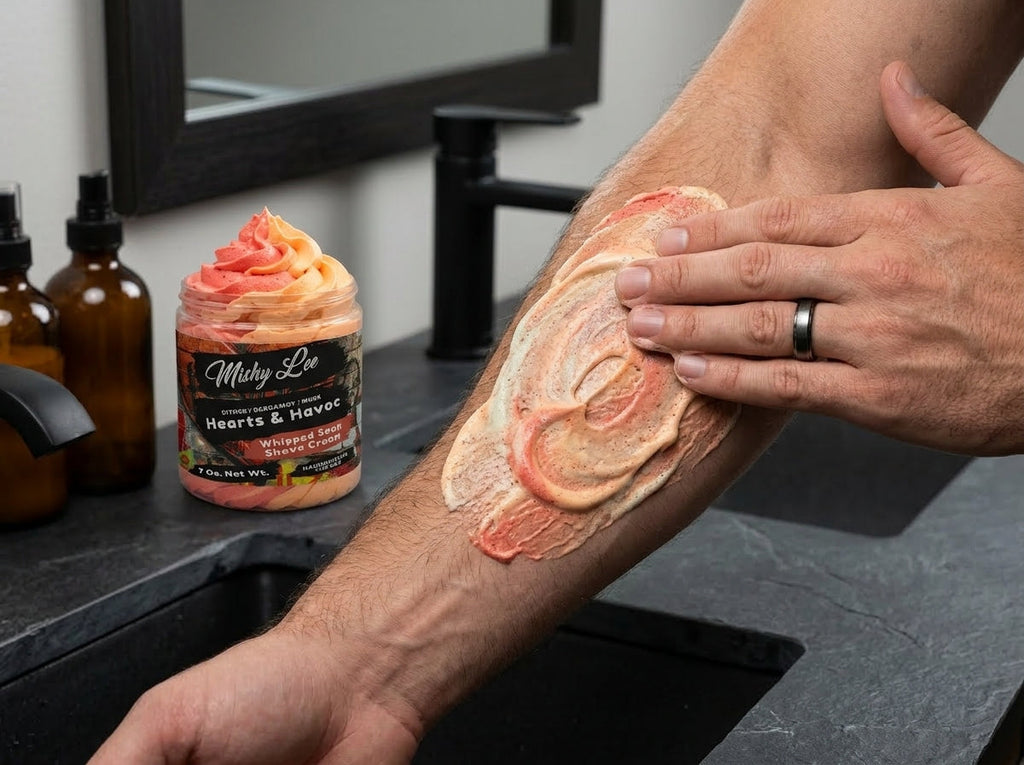 Man applying whipped soap and shave cream to arm; jar in background with Hearts & Havoc label