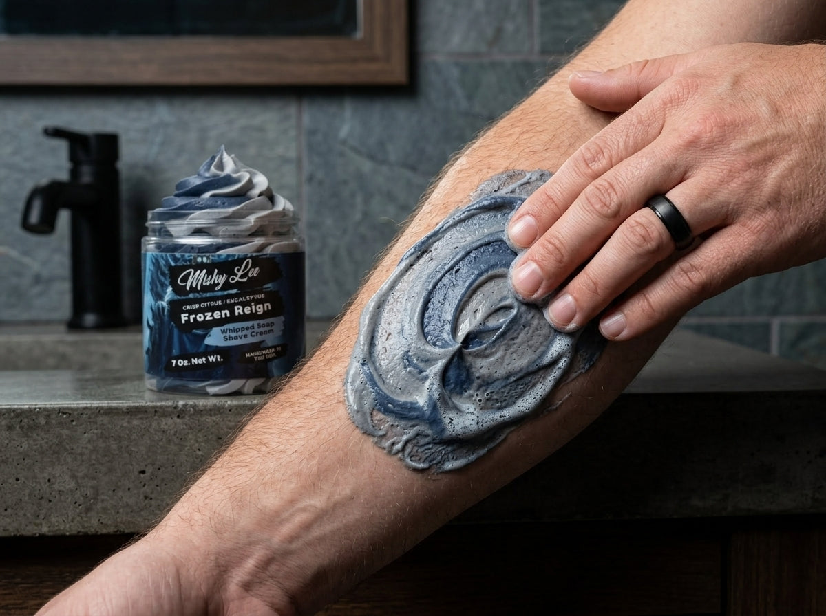 Man using navy whipped shave cream on leg with jar in background