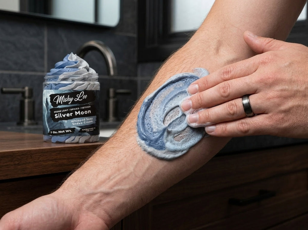 Blue whipped soap lather being rubbed on forearm near a Mushy Lee jar