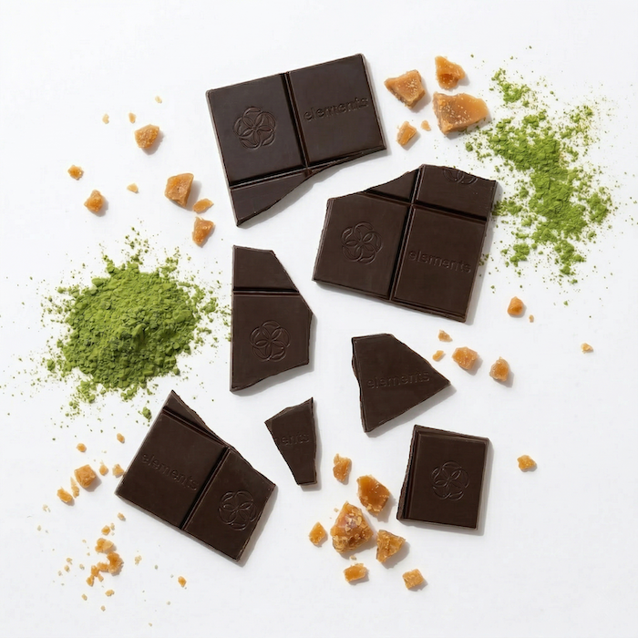 Maple toffee chocolate bar pieces with caramel crumbs and green powder around them