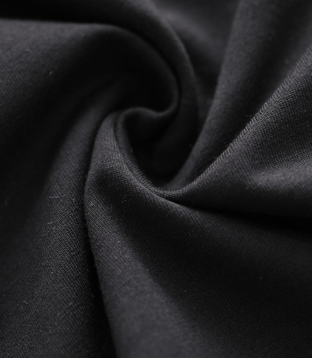 Close-up of dark charcoal knit fabric with smooth, fine texture