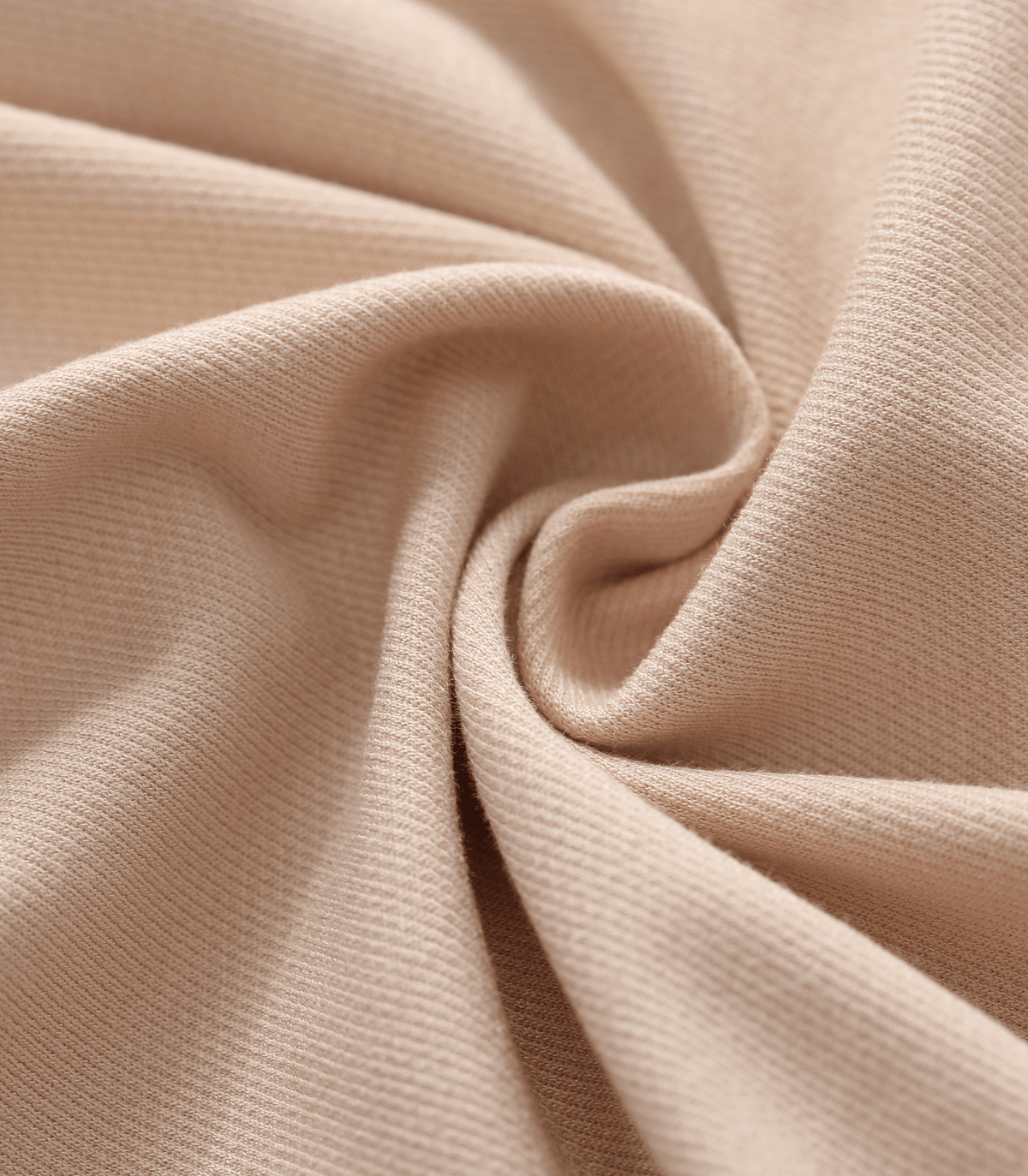 Close-up fabric texture of maternity trouser pants in light beige with fine weave
