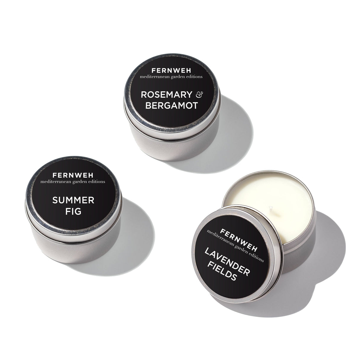 Assorted candle tins: Rosemary & Bergamot, Summer Fig, Lavender Fields, one open with wax