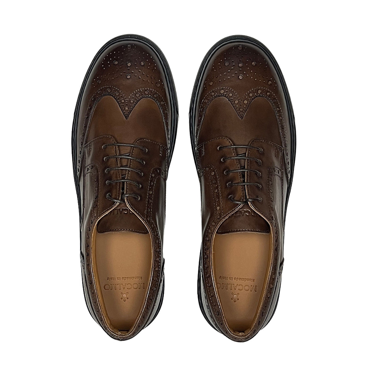 Pair of men's brown wingtip oxford shoes with laces and perforated brogue pattern