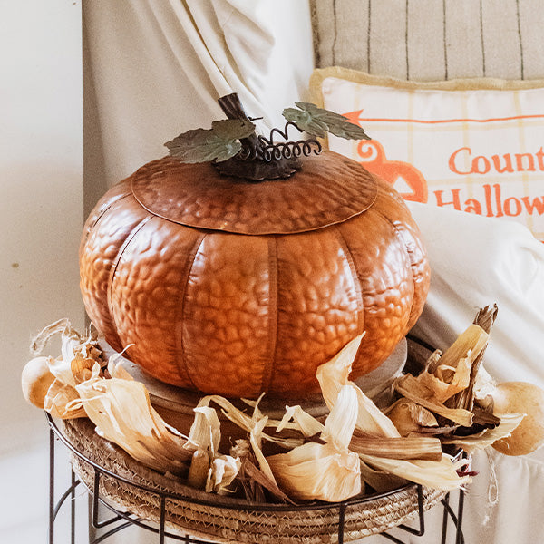 Metal pumpkin container with removable lid, embossed orange texture and leaf accents