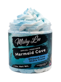 Light blue whipped soap and shave cream in a clear jar with blue swirl top.