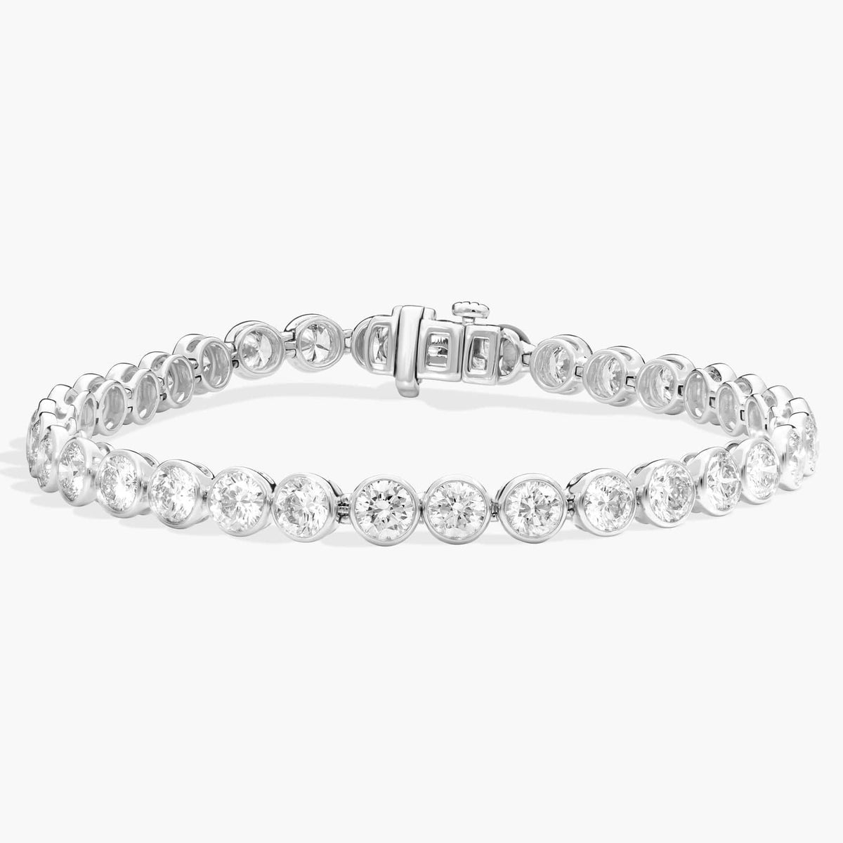 Silver-tone bezel-set round tennis bracelet with continuous sparkling stones, 7-inch length.
