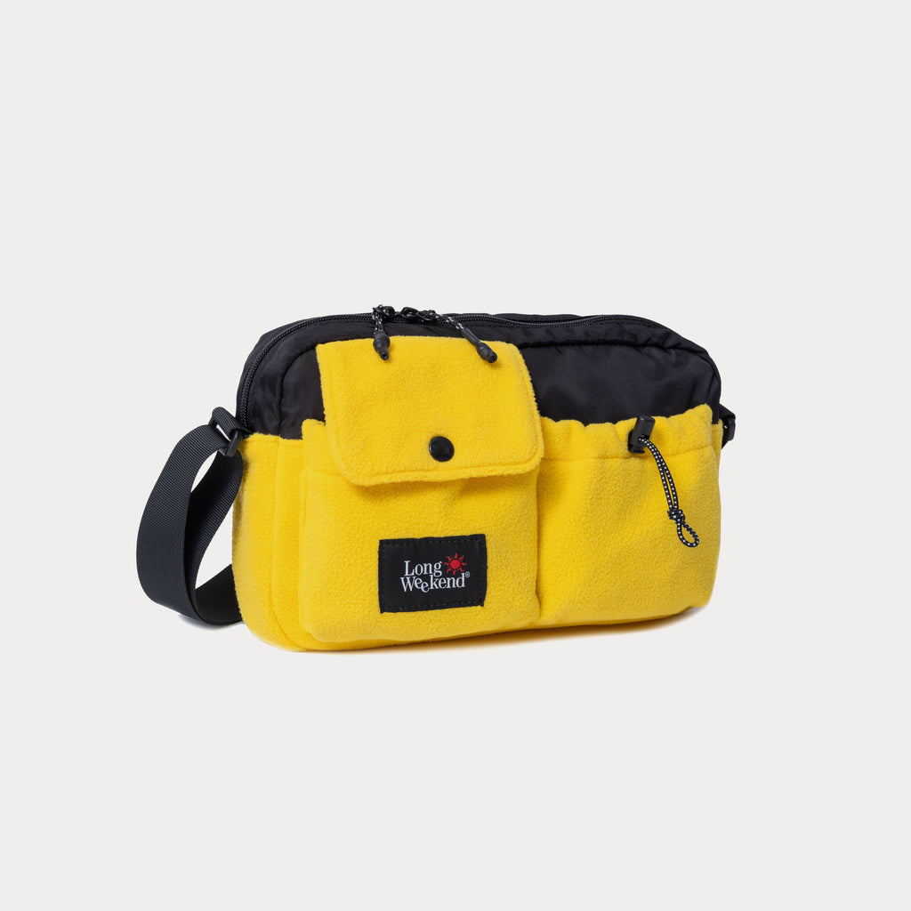 Yellow shoulder bag with black trim, front pouch and Long Weekend patch