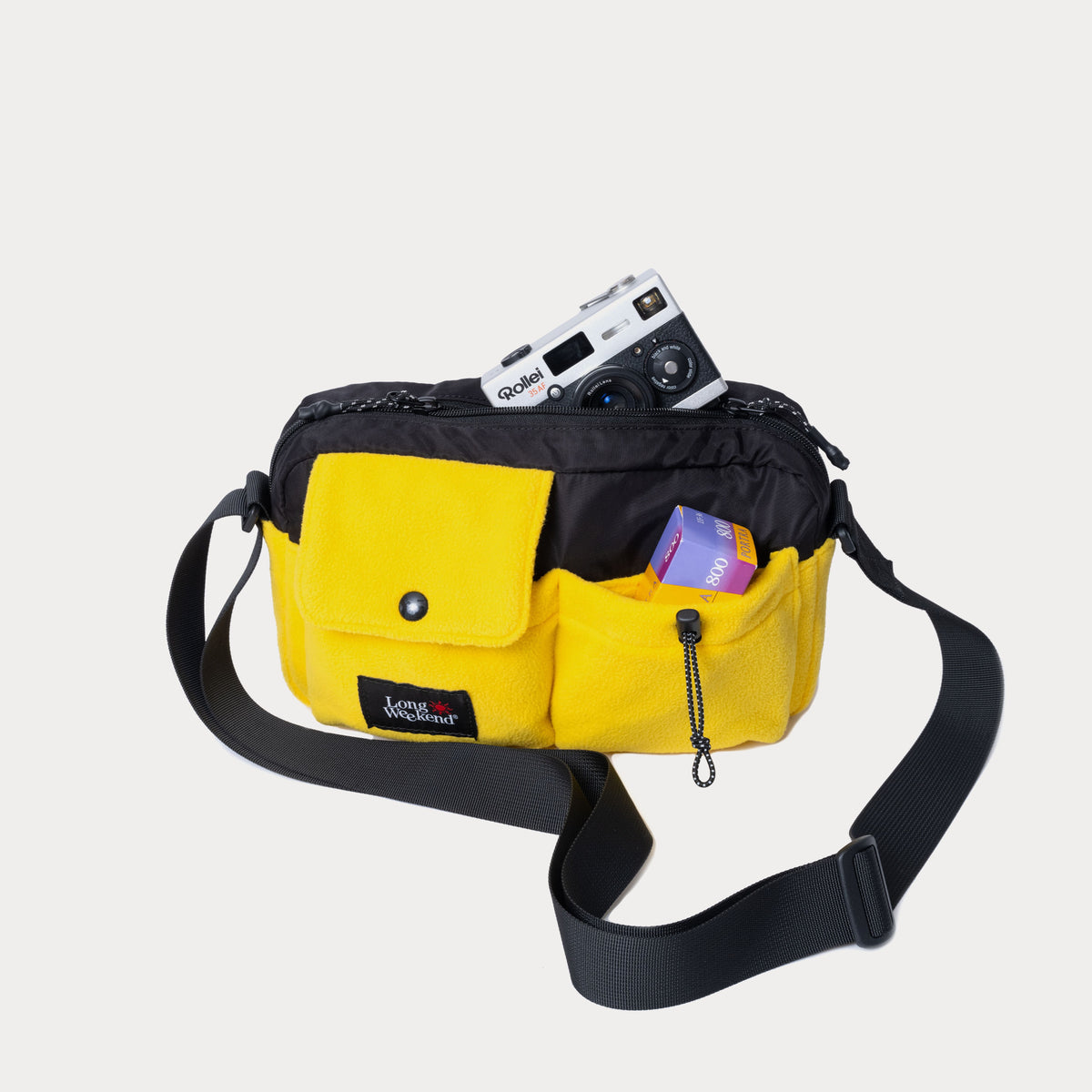 Black and yellow camera shoulder bag with front pockets and adjustable strap