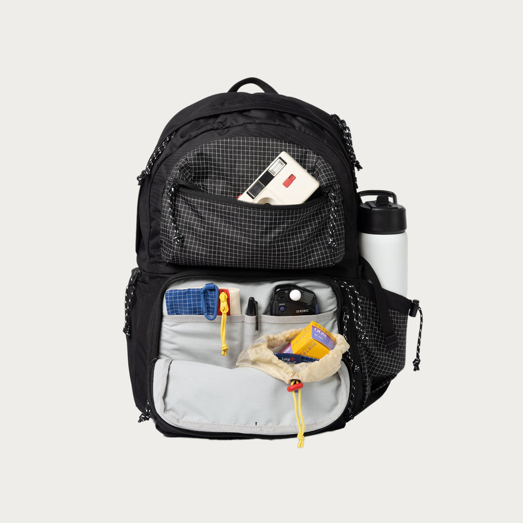 Black convertible backpack open, showing front compartments and pockets